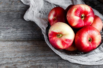 Donut peaches in bowl on wooden background