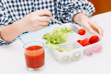 Woman eating fruit and vegetables in the kitchen.healthy lifestyle concept