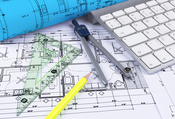 Architectural blueprints drawings of the modern house with computer keyboard. Architectural blueprints and blueprint rolls and a drawing instruments on the worktable. Drawing compass, plans.