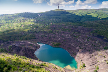 aerial view of deep mine lake in place of the mining pit