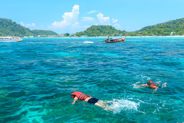 Tourists swimming and snorkeling in Andaman sea at Phi Phi islands one of the most beautifull island in Thailand