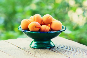 Apricots in the garden on a wooden table