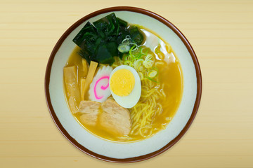 The ramen noodles pork Japanese food in bowl on wood top table image top view.
