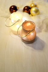 two tea lights in glass lantern with four christmas baubles