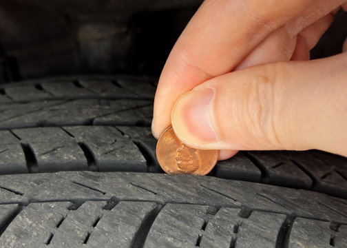 Checking tire tread depth and wear with a penny on Lincoln's head