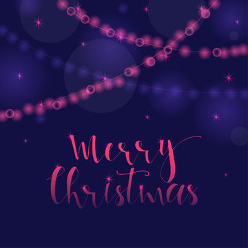 Wonderful and unique festive purple luminous background with Christmas wishes for holiday greeting cards. Hand drawn lettering with blurred bokeh.