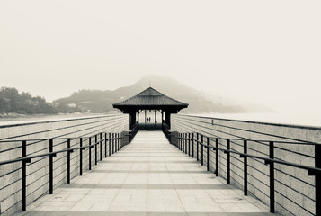 Pier aganst a foggy sky