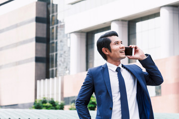 Handsome businessman using his smartphone