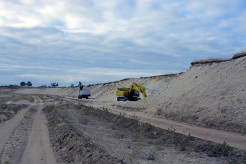 old abandoned yellow excavator in sandpit