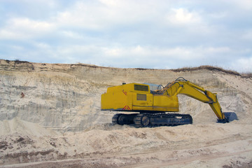 old abandoned yellow excavator in sandpit