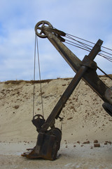 old abandoned yellow excavator in sandpit