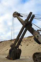 old abandoned yellow excavator in sandpit
