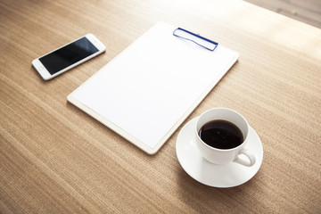 clipboard with stationarys on the wood desk(table) at the day light.