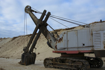 old abandoned yellow excavator in sandpit