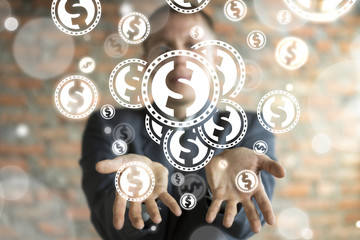 Businessman on blurred background using virtual screen gives dollar coins in his hands. Finance Banking Trade Market concept.