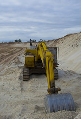 old abandoned yellow excavator in sandpit