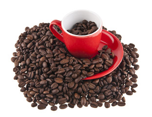 red cup and coffee grains isolated on white background close-up