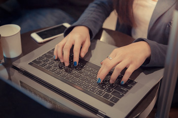 Closeup hand businesswoman working with laptop.