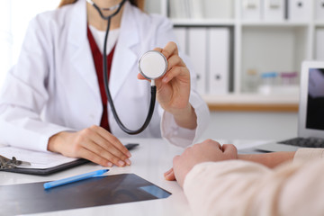 Unknown female doctor with a stethoscope in the hands. Physician is redy to exemine a patient