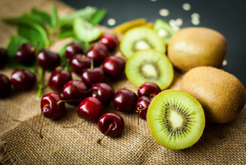 Organic kiwi & Cherry fruit isolated on the black background