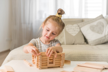 Portrait of little girl with house model