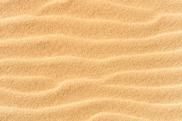 Fototapeta na wymiar Sand texture on the beach with waves as natural tropical background
