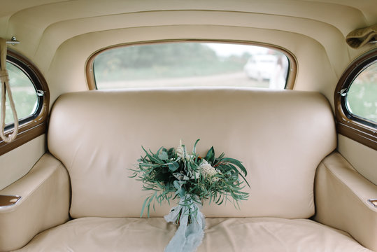 Green Wedding Bouquet In Retro Car