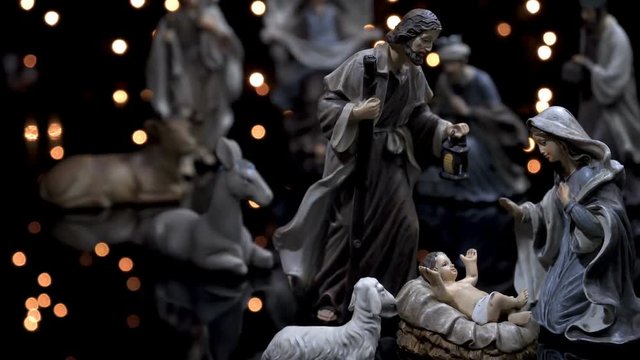 Nativity scene Christmas manger with figures and atmospheric lights. Dolly shot in 4k.