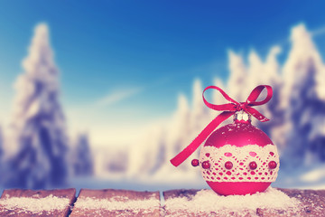 rote Weihnachtskugel im Winterwald