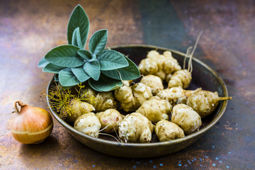 Autumn harvest - Jerusalem artichoke tubers in old bowl.