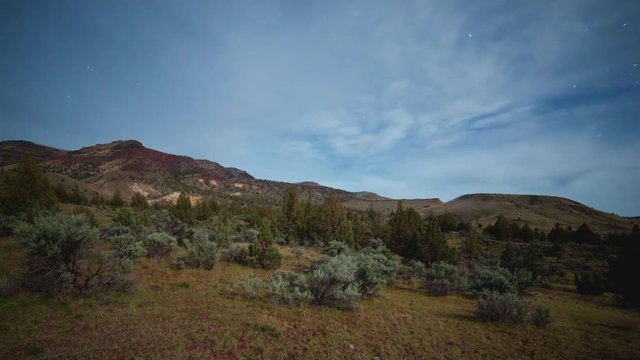 Milky way rise over desert mountain over moonset western juniper sage brush near john day fossil beds Sutton mountain