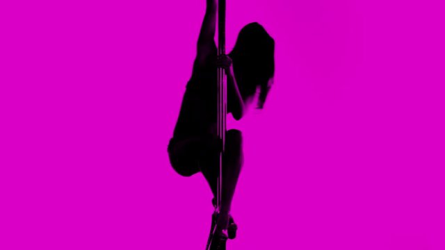 amazing pole dancer showing her skills against a white background