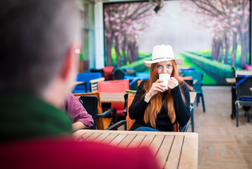 Beautiful girl drinking coffee at the coffee shop