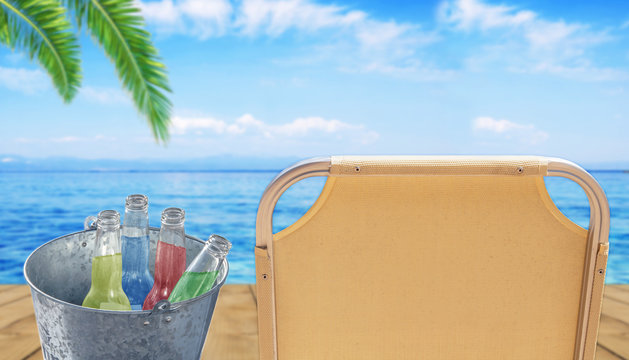Bucket with four bottle of refreshment drink at wooden terrace with sunbed and blue sea background