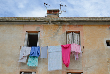 Wall with the windows and drying clothes