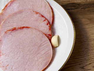 Pickled tenderloins in a plate on wood background