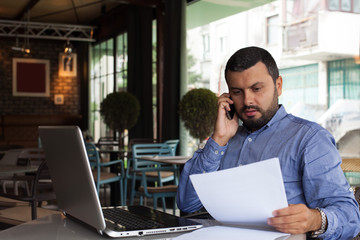 Handsome businessman talking on phone