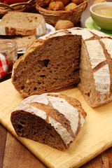 Country bread on the wooden cutting board    