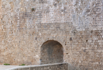 Fototapeta na wymiar Castle entrance with big stone architecture wall background