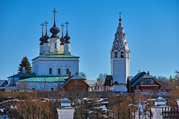 Orthodox church and bell tower/City landscape of Suzdal. On the hill there is a white-stone Orthodox church. Nearby stands the bell tower.Suzdal.Golden Ring of Russia