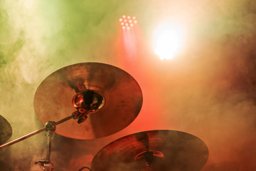 Copper plate drums close-up at a concert with multi-colored lighting in a smoke
