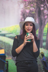 Beautiful girl drinking coffee at the coffee shop