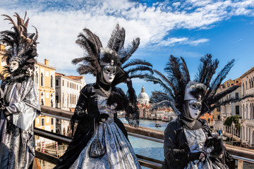 Fototapeta premium Carnival masks on bridge against Grand Canal in Venice, Italy