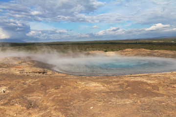 Iceland landscape. Steaming hot geothermal water sources. Famous geologic features. Selective focus.