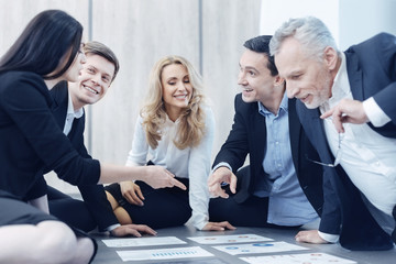 Positive delighted blonde looking at diagrams