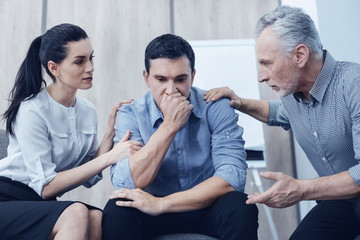 Obraz premium Serious man covering his mouth