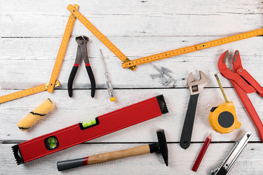 DIY construction tools for home improvement on white wooden background