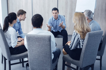 Obraz premium Group of workers sitting in circle
