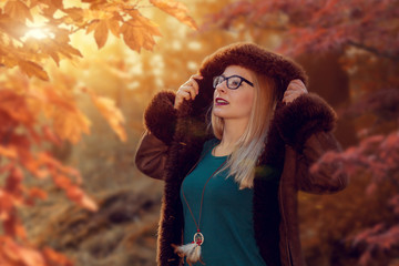 Portrait of a young woman on an autumn background