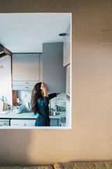 Woman posing at kitchen in morning